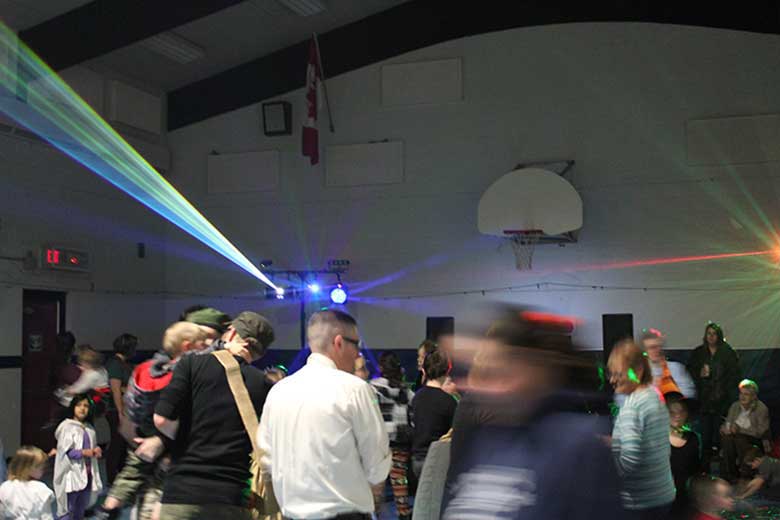 School Light Show, Family Dance, Hamilton DJ, light show in background guests dancing photo is blurred as some people are moving quickly. Taken in Hamilton Ontario.